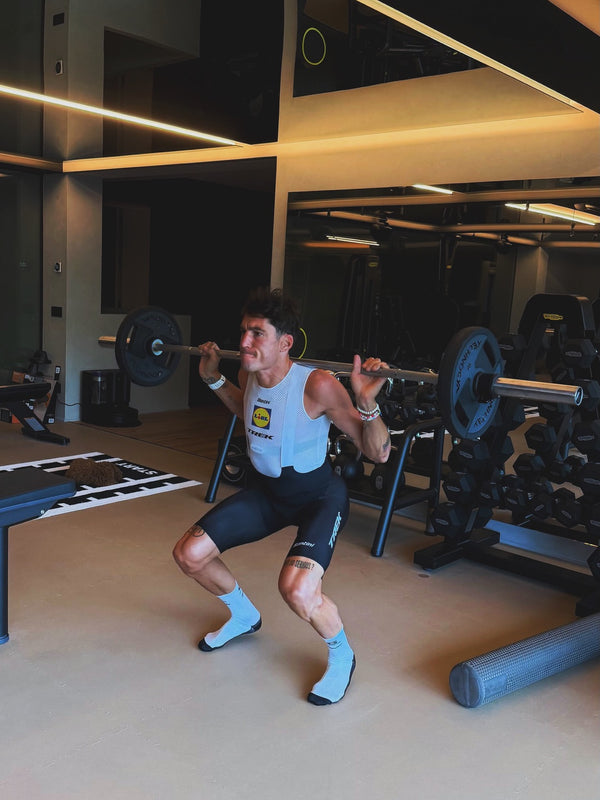 Doing barbell squats in a home gym