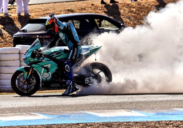 Rider doing a burnout on the No. 53 bike