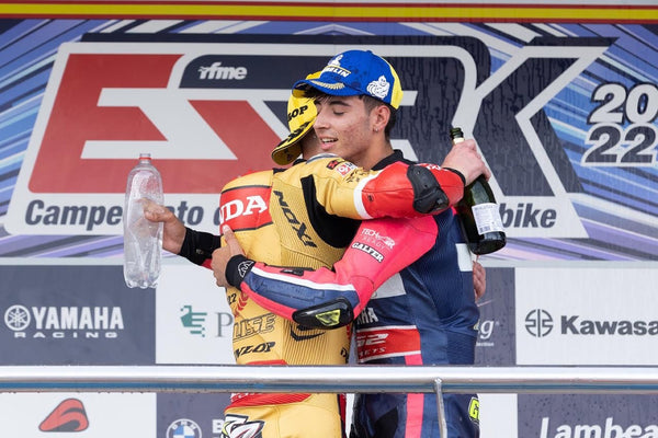 Two riders celebrating on the podium