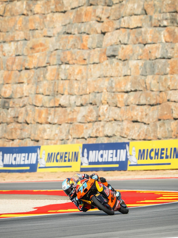 Red Bull KTM rider cornering past Michelin boards